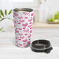 Pink Heart Doodles Travel Mug (15oz) at Amy's Coffee Mugs. A stainless steel travel mug designed with hand-drawn pink heart doodles in a pattern that wraps around the travel mug. This cute heart pattern is perfect for Valentine's Day or for anyone who loves hearts and young-at-heart drawings. Photo shows the travel mug open with the lid on the table beside it.