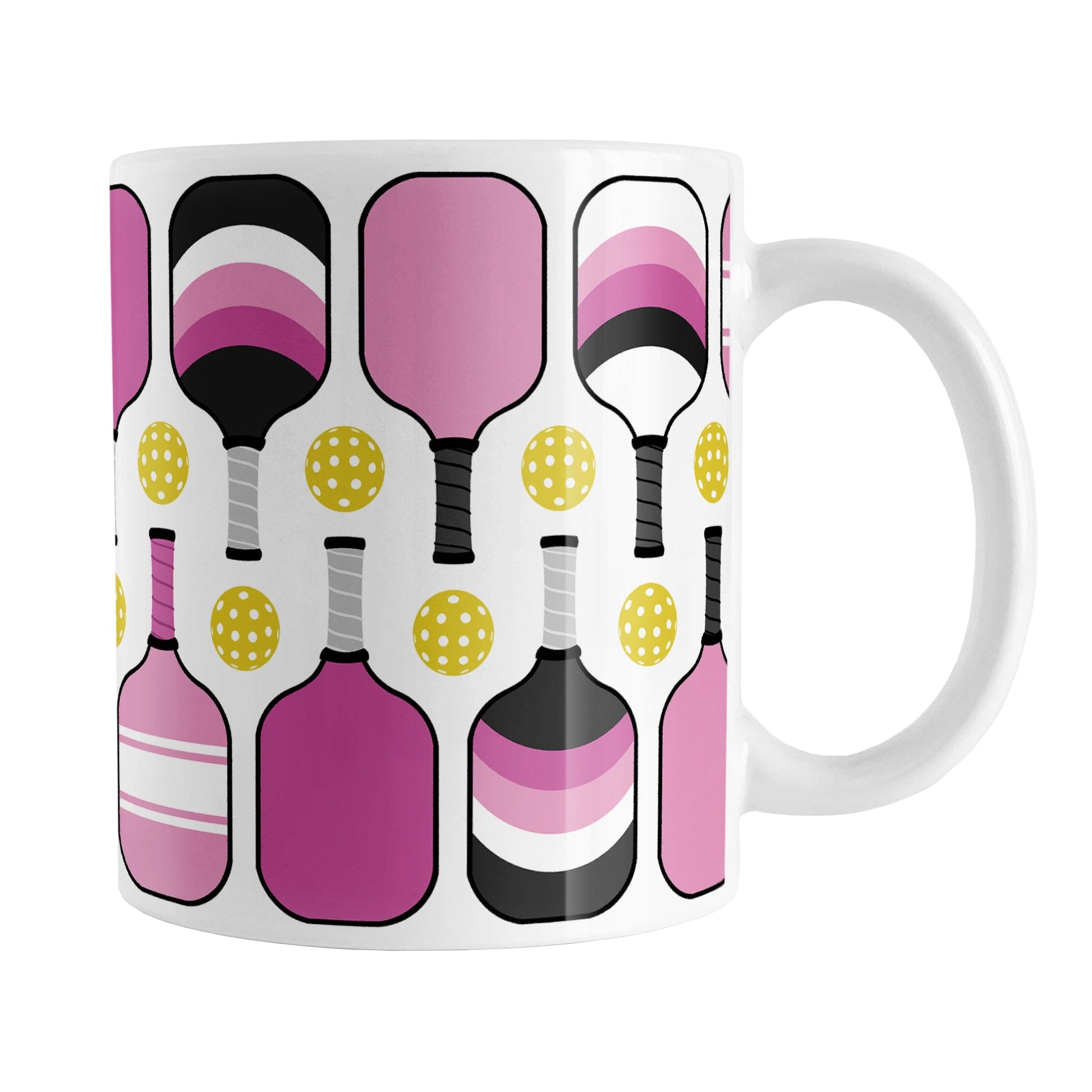 Pink Pickleball Mug (11oz) at Amy's Coffee Mugs. A ceramic coffee mug designed with modern pink pickleball paddles and yellow balls in a pattern that wraps around the mug up to the handle.