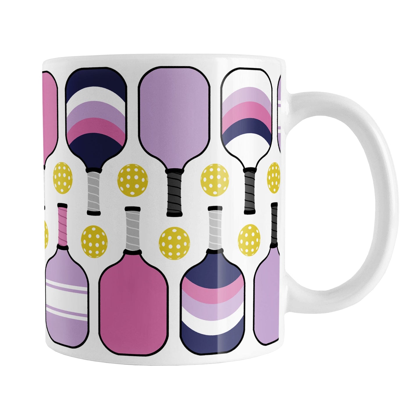 Pink Purple Navy Pickleball Mug (11oz) at Amy's Coffee Mugs. A ceramic coffee mug designed with modern pickleball paddles in bold pink, light purple, and dark navy blue, along with yellow balls in a pattern that wraps around the mug up to the handle.