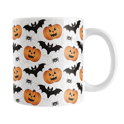 11oz Halloween-themed mug with pumpkins, bats, and spiders on a white background