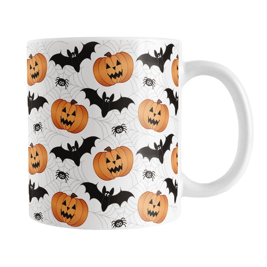 11oz Halloween-themed mug with pumpkins, bats, and spiders on a white background