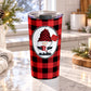 20 oz red gnome buffalo plaid tumbler cup with winter gnome holding a red mug and snow shovel on a red and black buffalo check background, on a granite countertop in a kitchen with light rustic winter decor including pine cones, pine boughs, and a cozy blanket.