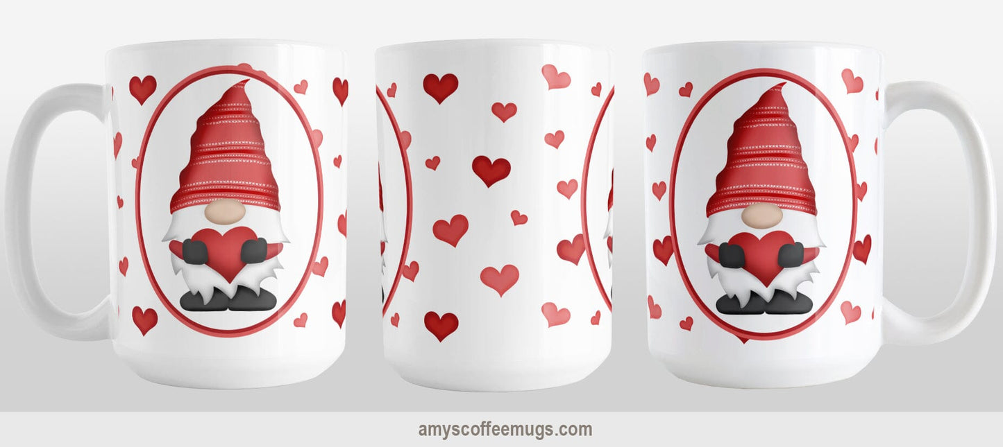 Red Gnome Dainty Hearts Mug (15oz) at Amy's Coffee Mugs. A ceramic coffee mug designed with an adorable red gnome in a white oval on both sides of the mug over a pattern of cute dainty hearts in different shades of red that wrap around the mug to the handle. Photo shows three sides of the mug so that you can see the entire printed design.