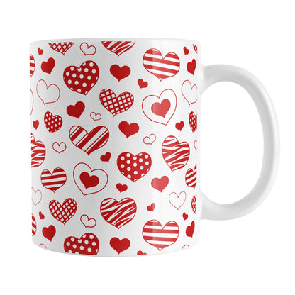 Red Heart Doodles Mug (11oz) at Amy's Coffee Mugs. A ceramic coffee mug designed with hand-drawn red heart doodles in a pattern that wraps around the mug up to the handle. This cute hearts pattern is perfect for Valentine's Day or for anyone who loves hearts and young-at-heart drawings. 