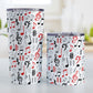 Red Music Notes Pattern Tumbler Cups (20oz or 10oz) at Amy's Coffee Mugs. Stainless steel tumbler cups designed with music notes and symbols in red, black, and gray in a pattern that wraps around the cups. Photo shows both cups on a table next to each other. 