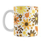 11oz white mug with a floral pattern featuring orange, yellow, and brown flowers