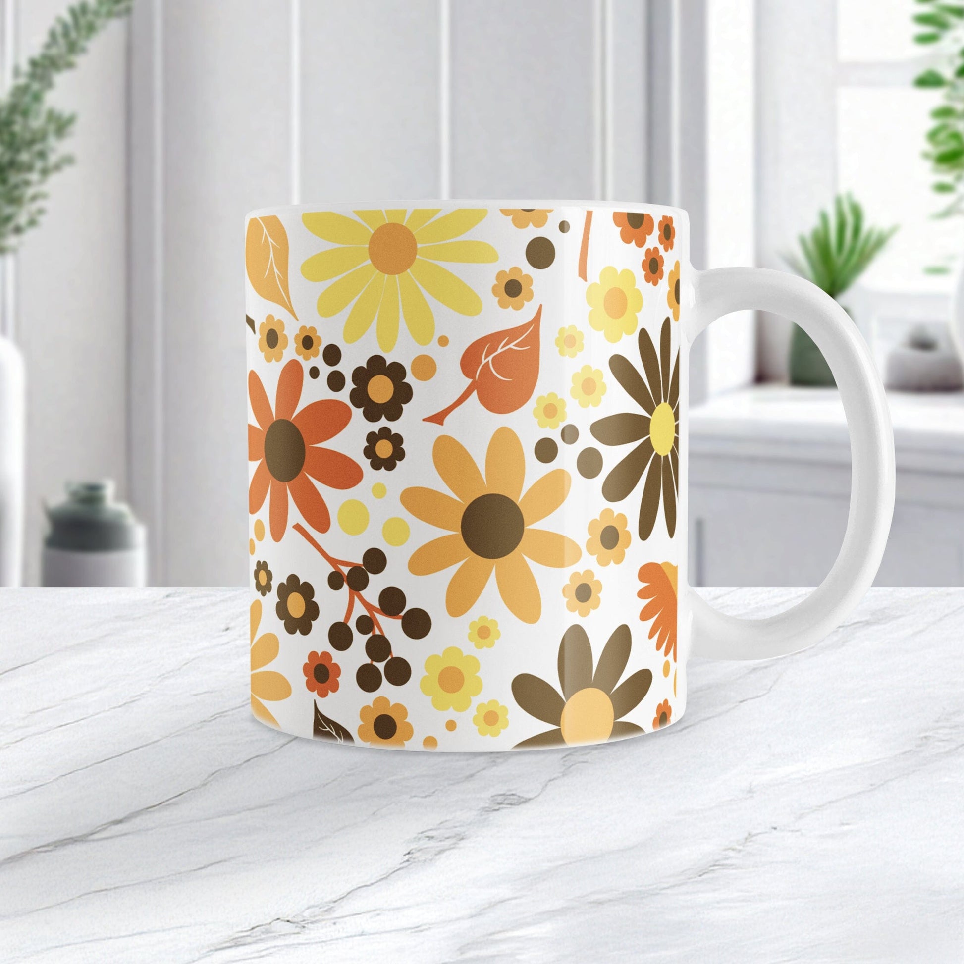 11oz white mug with a floral pattern featuring orange, yellow, and brown flowers, sitting on a marble countetop