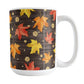 Rustic Wood Falling Leaves Autumn Mug (15oz) at Amy's Coffee Mugs. A fall-inspired ceramic mug featuring leaves in orange, red, and yellow, with gold-colored circles, spread out in a falling pattern over a rich, dark brown wood background design that wraps around the mug up to the handle.