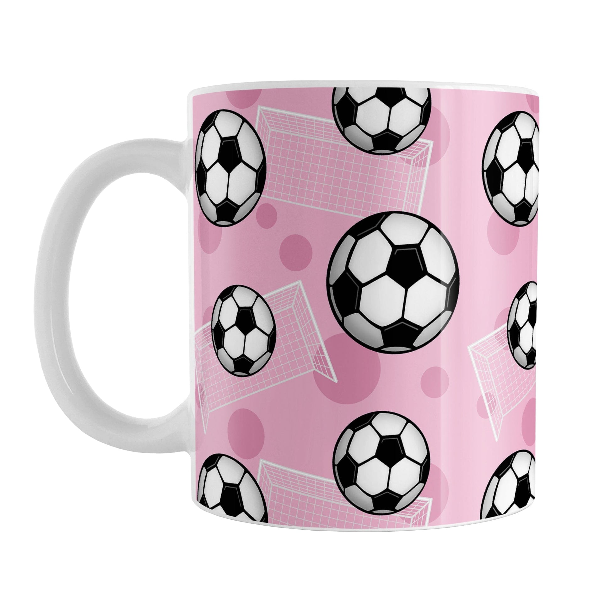 Soccer Ball and Goal Pattern Pink Mug (11oz) at Amy's Coffee Mugs. A ceramic coffee mug designed with a pattern of soccer balls and white soccer goals over a pink background with pink circles.