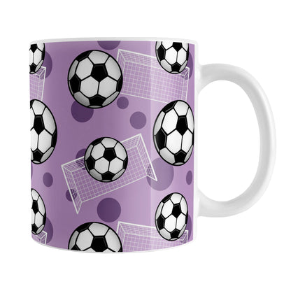 Soccer Ball and Goal Pattern Purple Mug (11oz) at Amy's Coffee Mugs. A ceramic coffee mug designed with a pattern of soccer balls and white soccer goals over a purple background with purple circles.