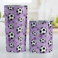 Soccer Ball and Goal Pattern Purple Tumbler Cup (20oz and 10oz, stainless steel insulated) at Amy's Coffee Mugs. A tumbler cup designed with soccer balls and soccer goals over a purple background color in a pattern that wraps around the cup. Photo shows both sized cups on a table next to each other.