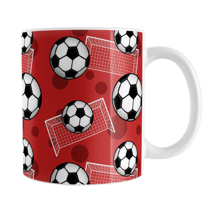 Soccer Ball and Goal Pattern Red Mug (11oz) at Amy's Coffee Mugs. A ceramic coffee mug designed with a pattern of soccer balls and white soccer goals over a red background with red circles.