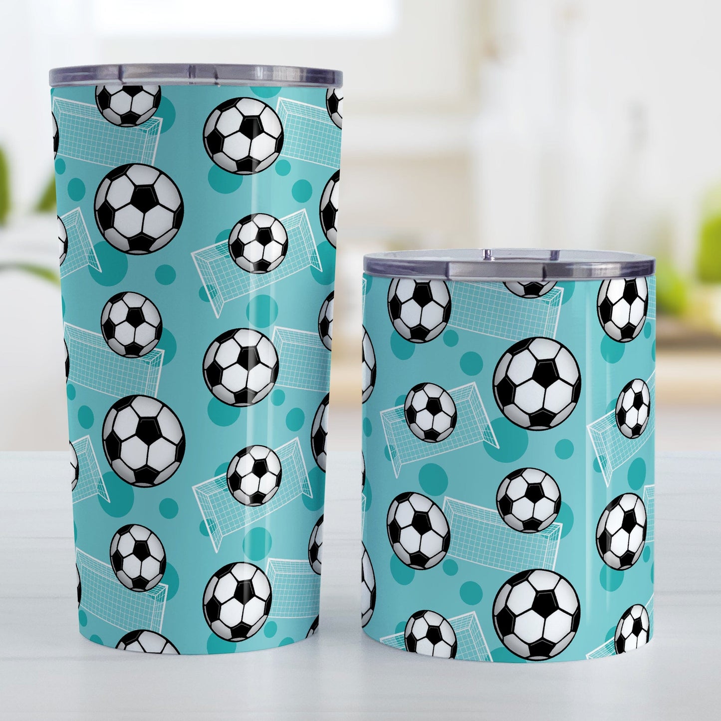 Soccer Ball and Goal Pattern Teal Tumbler Cup (20oz and 10oz) at Amy's Coffee Mugs. Stainless steel insulated tumbler cups designed with a pattern of soccer balls and goals over a teal background that wraps around the cups. These teal soccer tumbler cups are perfect for people who love or play soccer. Photo shows both sized cups next to each other.