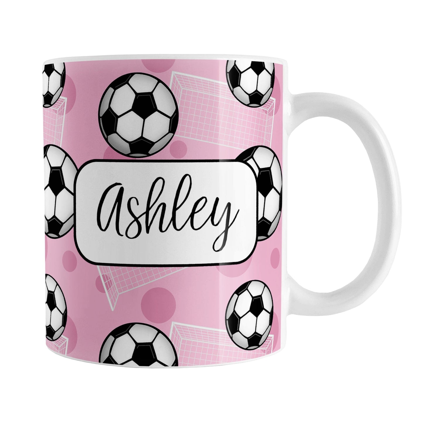 Soccer Ball and Goal Personalized Pink Soccer Mug (11oz) at Amy's Coffee Mugs. A ceramic coffee mug designed with a pattern of soccer balls and white soccer goals over a pink background with pink circles. Your personalized name is custom-printed in a fun black script font on both sides of the mug over the soccer pattern. 