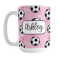 Soccer Ball and Goal Personalized Pink Soccer Mug (15oz) at Amy's Coffee Mugs. A ceramic coffee mug designed with a pattern of soccer balls and white soccer goals over a pink background with pink circles. Your personalized name is custom-printed in a fun black script font on both sides of the mug over the soccer pattern. 