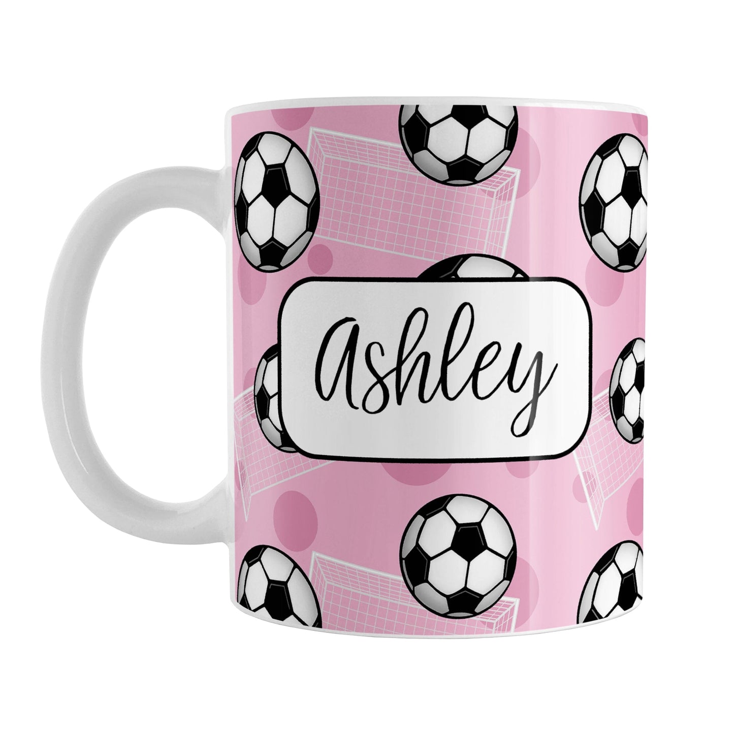 Soccer Ball and Goal Personalized Pink Soccer Mug (11oz) at Amy's Coffee Mugs. A ceramic coffee mug designed with a pattern of soccer balls and white soccer goals over a pink background with pink circles. Your personalized name is custom-printed in a fun black script font on both sides of the mug over the soccer pattern. 