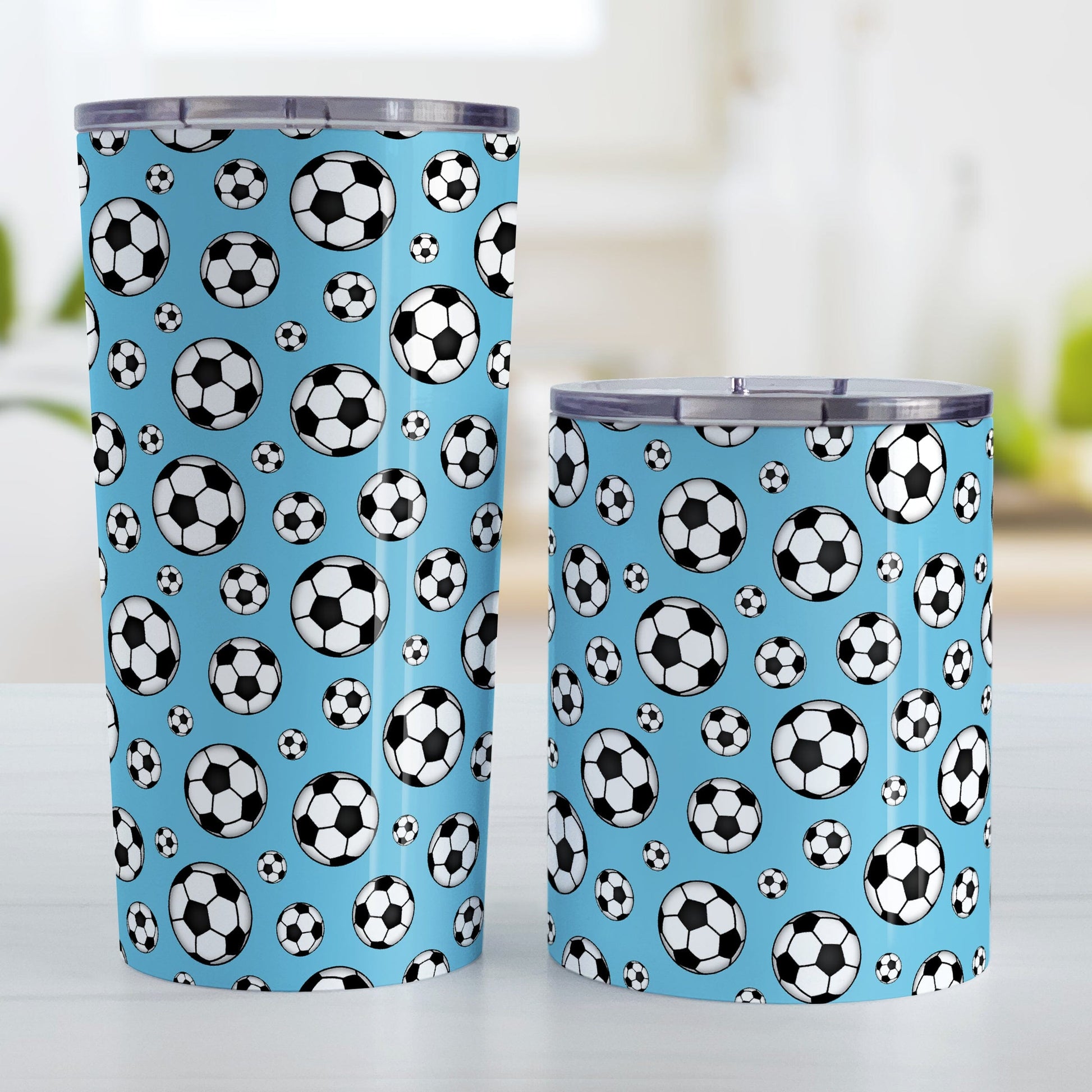 Soccer Balls on Blue Tumbler Cup at Amy's Coffee Mugs. Photo shows the 20oz cup and the 10oz cup next to each other.