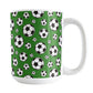 15oz white ceramic mug with a design of soccer balls over dark green