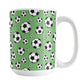 15oz white ceramic mug with a design of soccer balls over green
