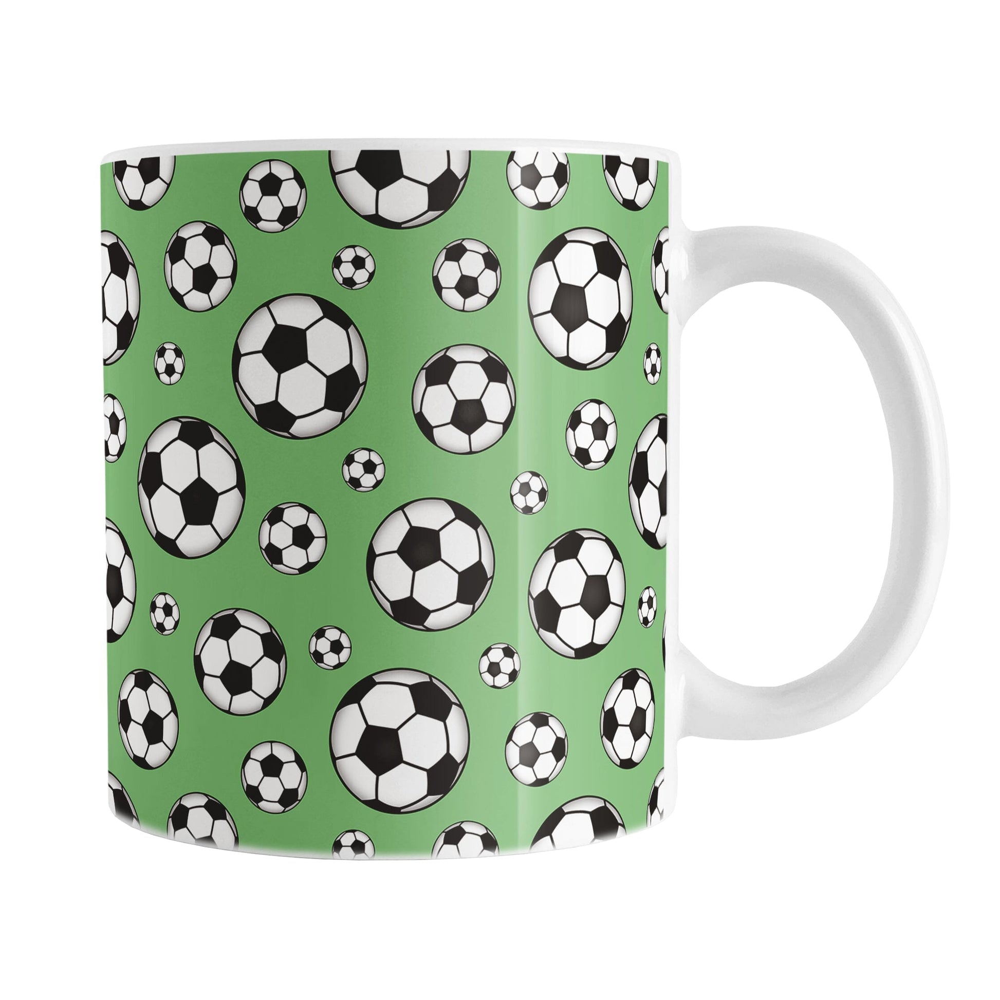 11oz white ceramic mug with a design of soccer balls over green