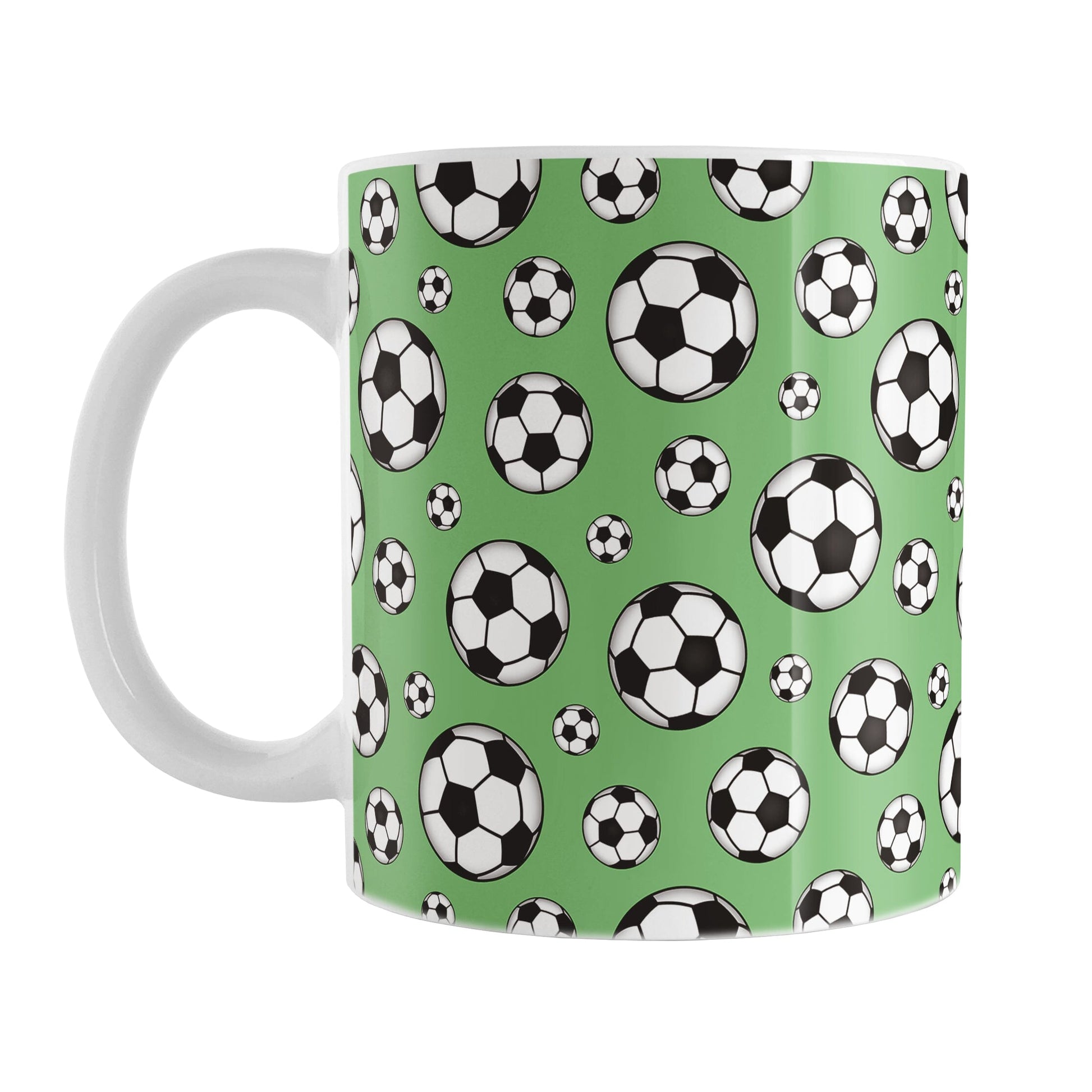 11oz white ceramic mug with a design of soccer balls over green