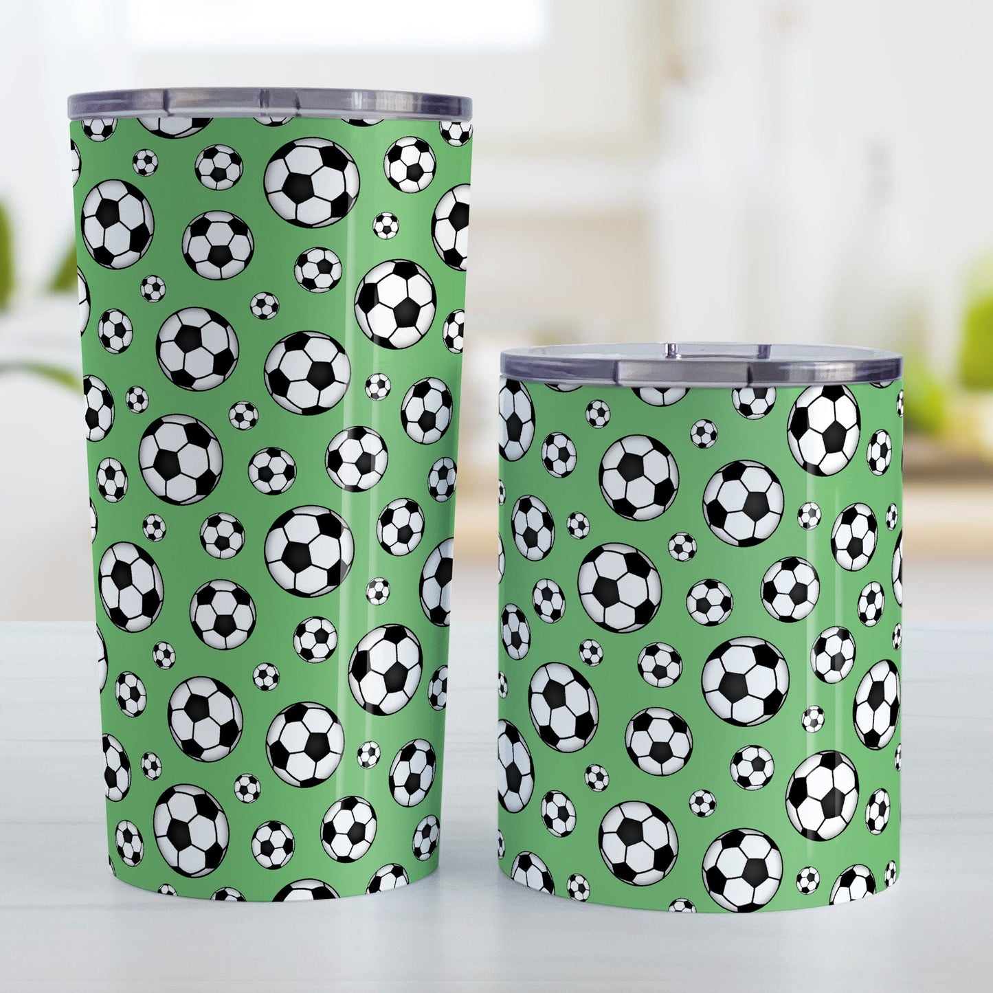 Soccer Balls on Green Tumbler Cup at Amy's Coffee Mugs. Photo shows the 20oz and 10oz cups on a table next to each other.