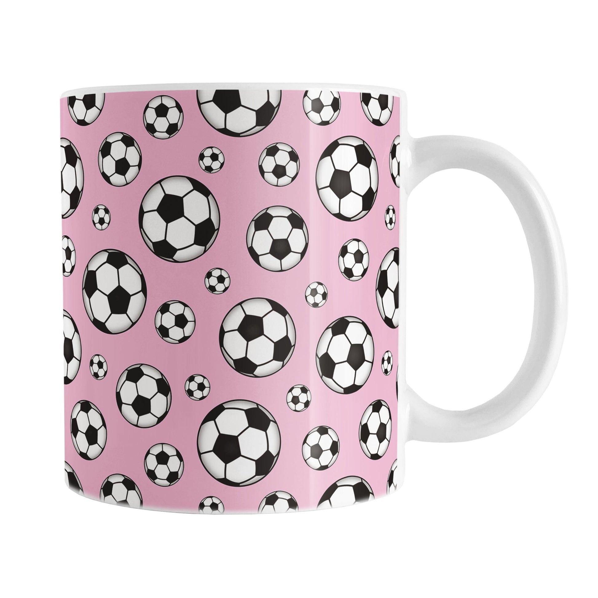 11oz white ceramic mug with a design of soccer balls over pink