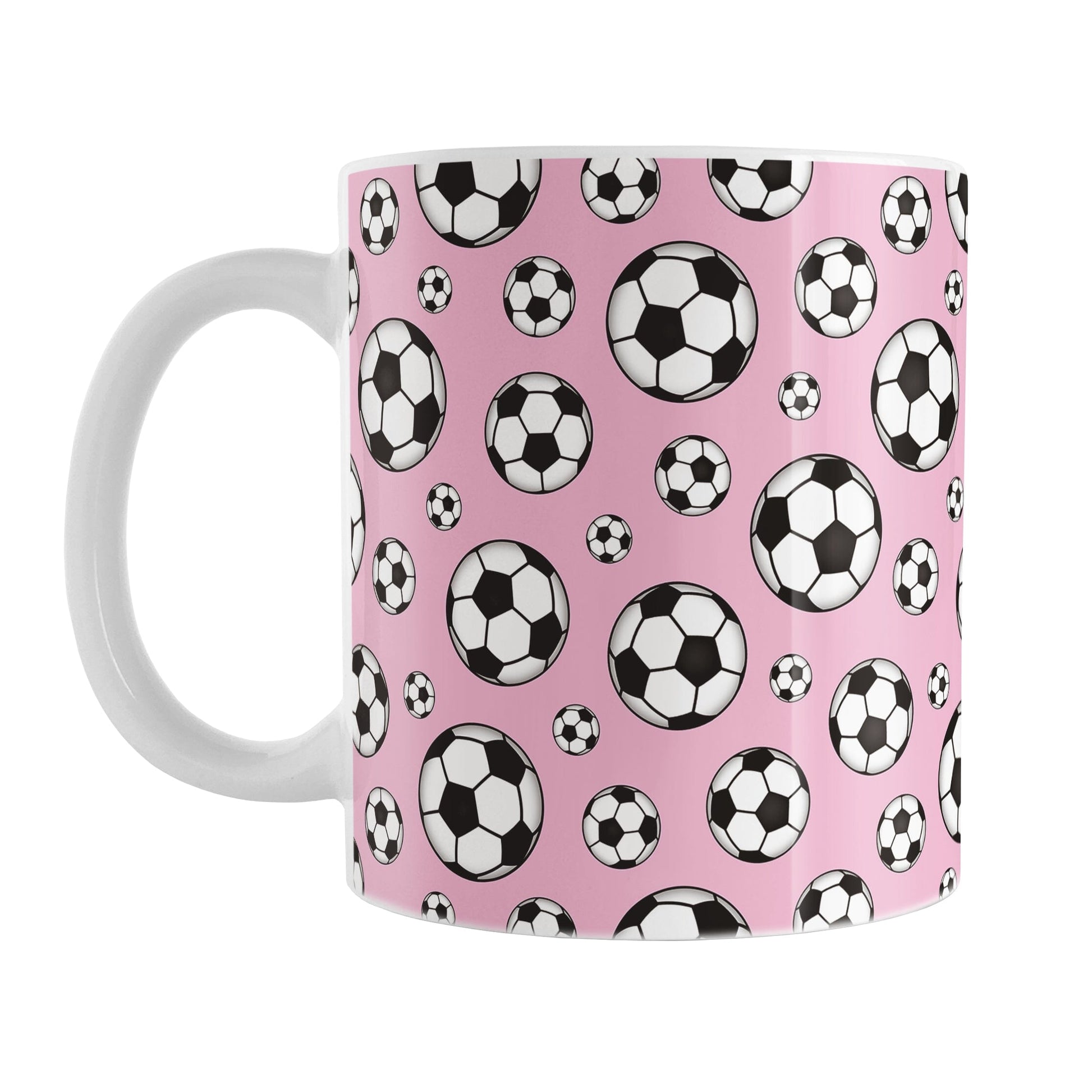 11oz white ceramic mug with a design of soccer balls over pink