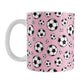 11oz white ceramic mug with a design of soccer balls over pink