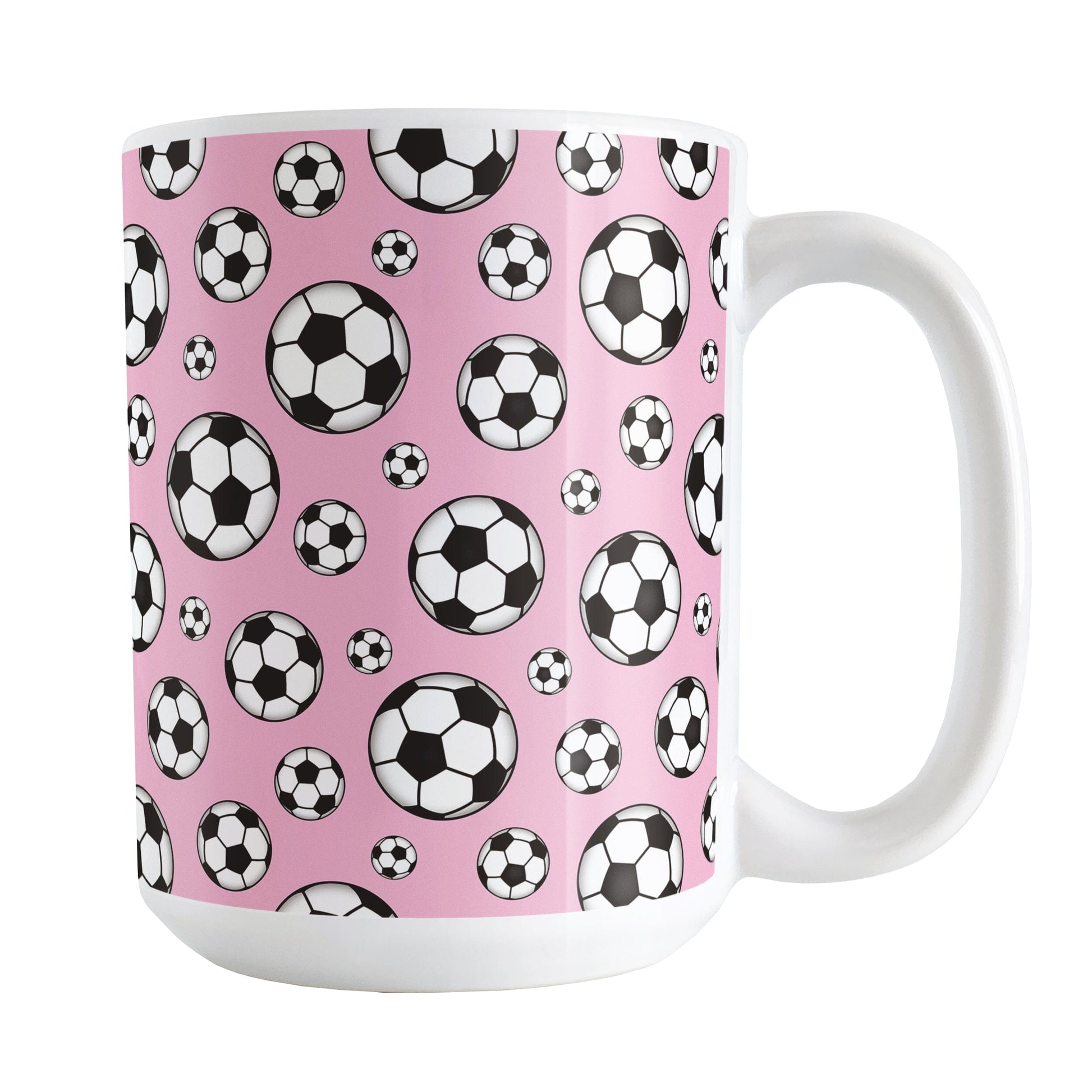 15oz white ceramic mug with a design of soccer balls over pink