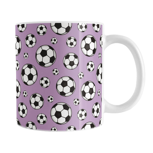 11oz white ceramic mug with a design of soccer balls over purple