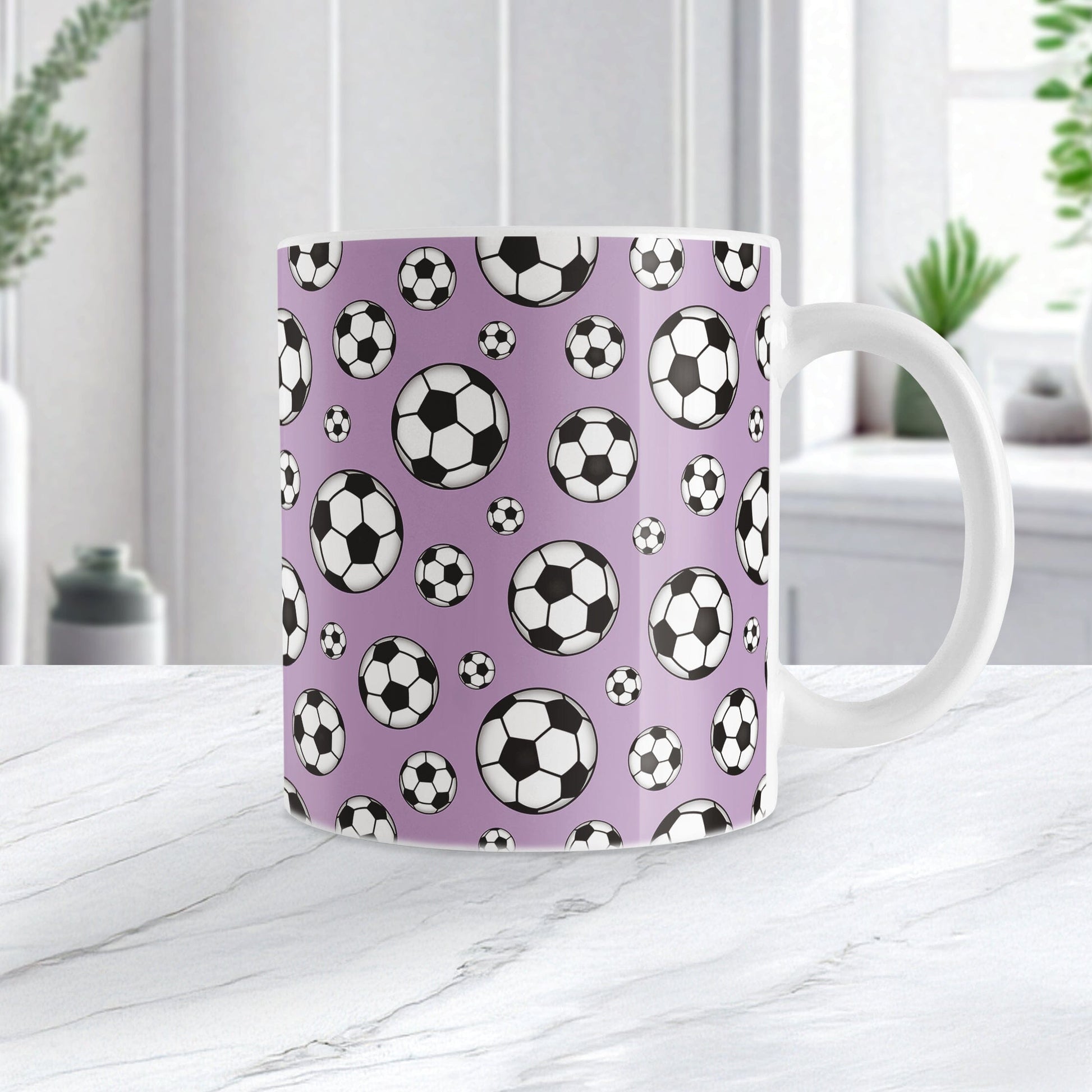 11oz white ceramic mug with a design of soccer balls over purple, on a marble countertop