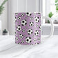 11oz white ceramic mug with a design of soccer balls over purple, on a marble countertop
