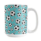 15oz white ceramic mug with a design of soccer balls over teal