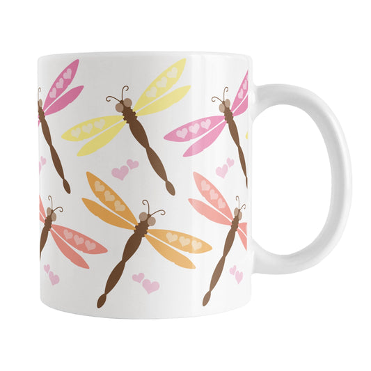 White mug with colorful dragonfly pattern on a white background