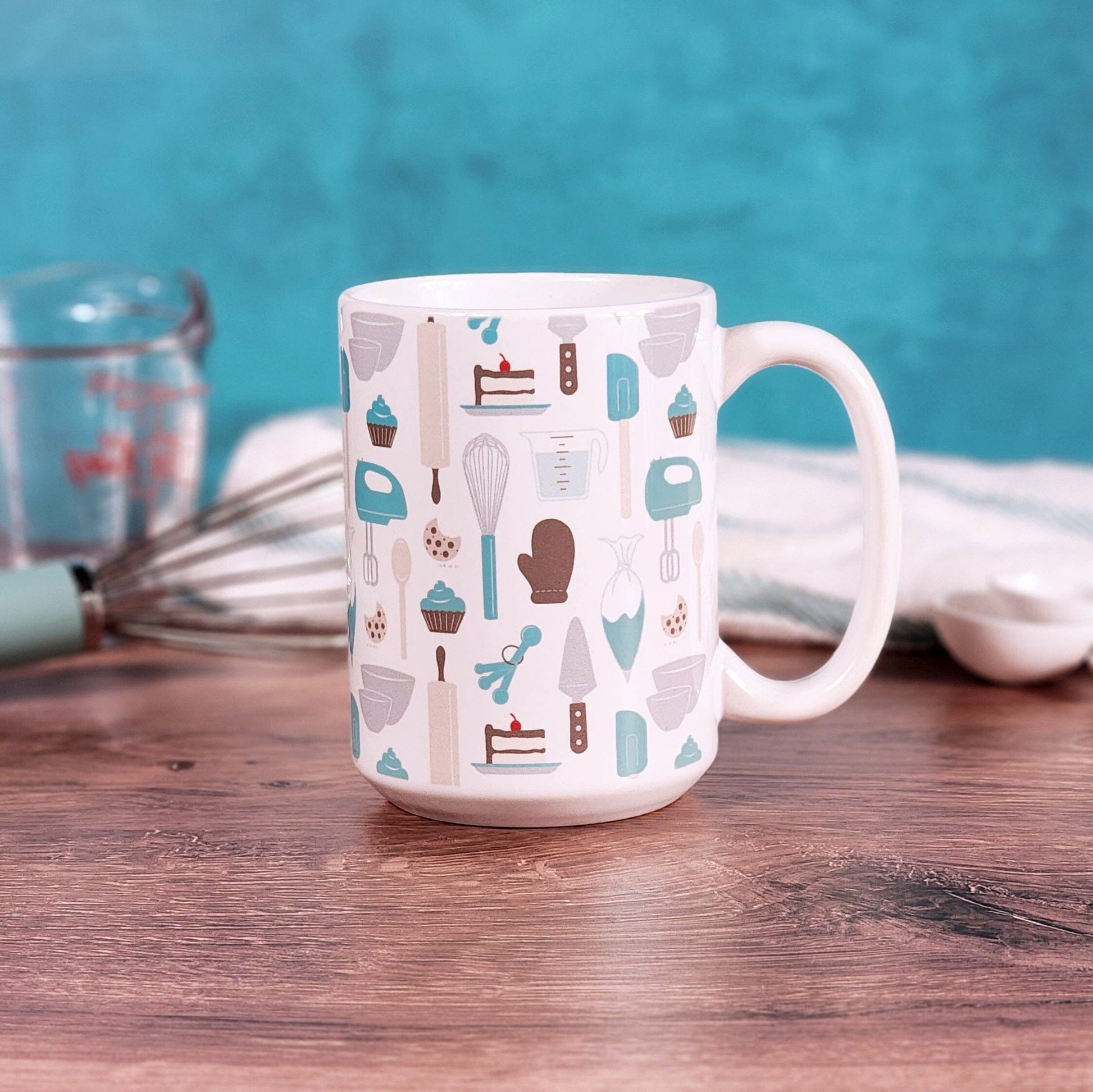 Turquoise Baking Pattern Mug (15oz) from Amy's Coffee Mugs on a table with baking supplies. 