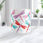 11oz white ceramic coffee mug with a colorful dragonfly design, perfect for Valentine's Day. Photo shows the mug on a marble countertop.