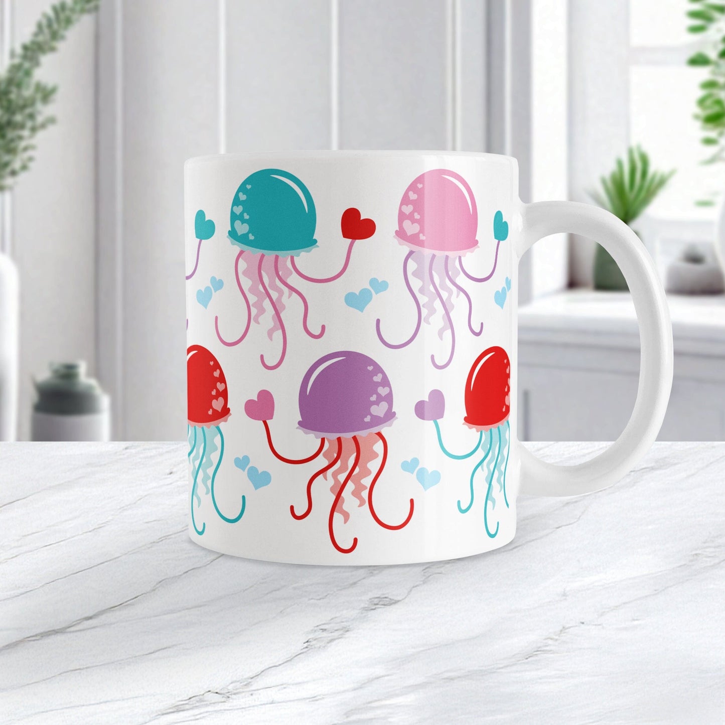 11oz white mug with a cute pattern of pink, purple, red, and teal jellyfish, perfect for Valentine's Day. Photo shows the mug on a marble countertop.