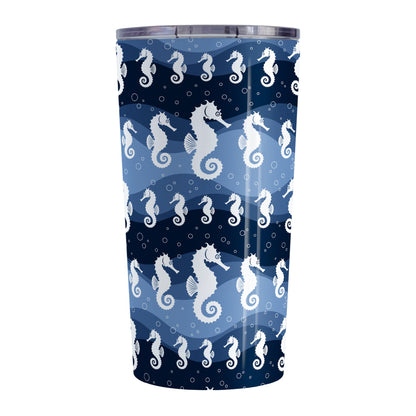 Wavy Blue Seahorse Tumbler Cup (20oz) at Amy's Coffee Mugs. A tumbler cup designed with white silhouette seahorses over a wavy blue background in different shades of navy blue with white circle line bubbles all in a pattern that wraps around the cup.