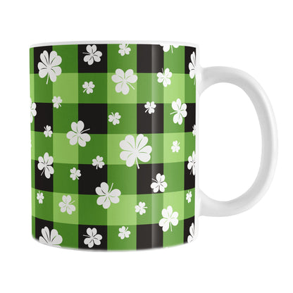 11oz mug with green and black checkered (buffalo plaid) pattern and white shamrocks and four-leaf clovers