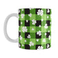 11oz mug with green and black checkered (buffalo plaid) pattern and white shamrocks and four-leaf clovers