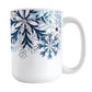 Winter Blue Silver Snowflake Mug (15oz) at Amy's Coffee Mugs. A ceramic coffee mug with navy blue, aqua blue, and silver-colored glitter-illustrated snowflakes along the top, cascading down most of the mug, over white. This wintry snowflake design wraps around the mug up to the handle.