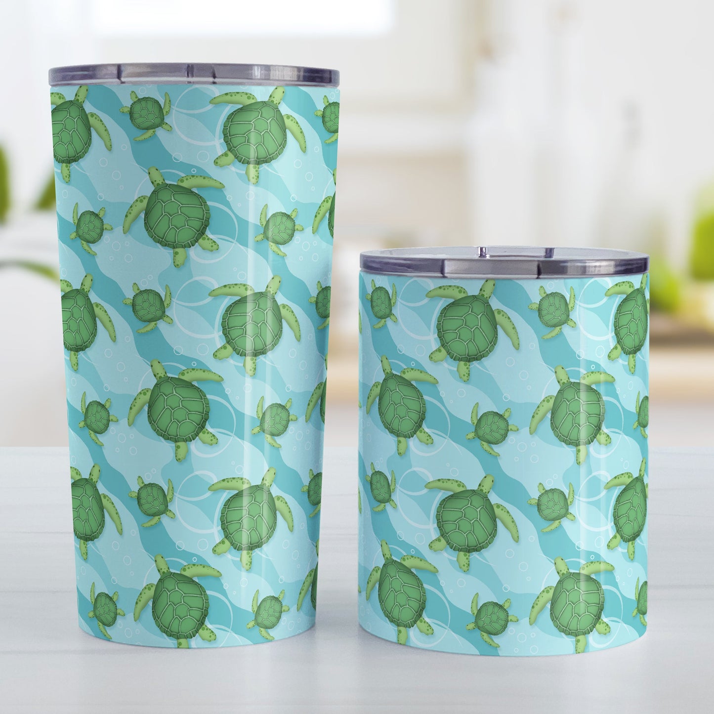 Aquatic Sea Turtle Pattern Tumbler Cup (20oz and 10oz, stainless steel insulated) at Amy's Coffee Mugs. Sea turtle tumbler cups with an aquatic pattern of green sea turtles, swimming over a wavy underwater pattern design in blue and turquoise, that wraps around the cups. The photo shows both sized cups next to each other.