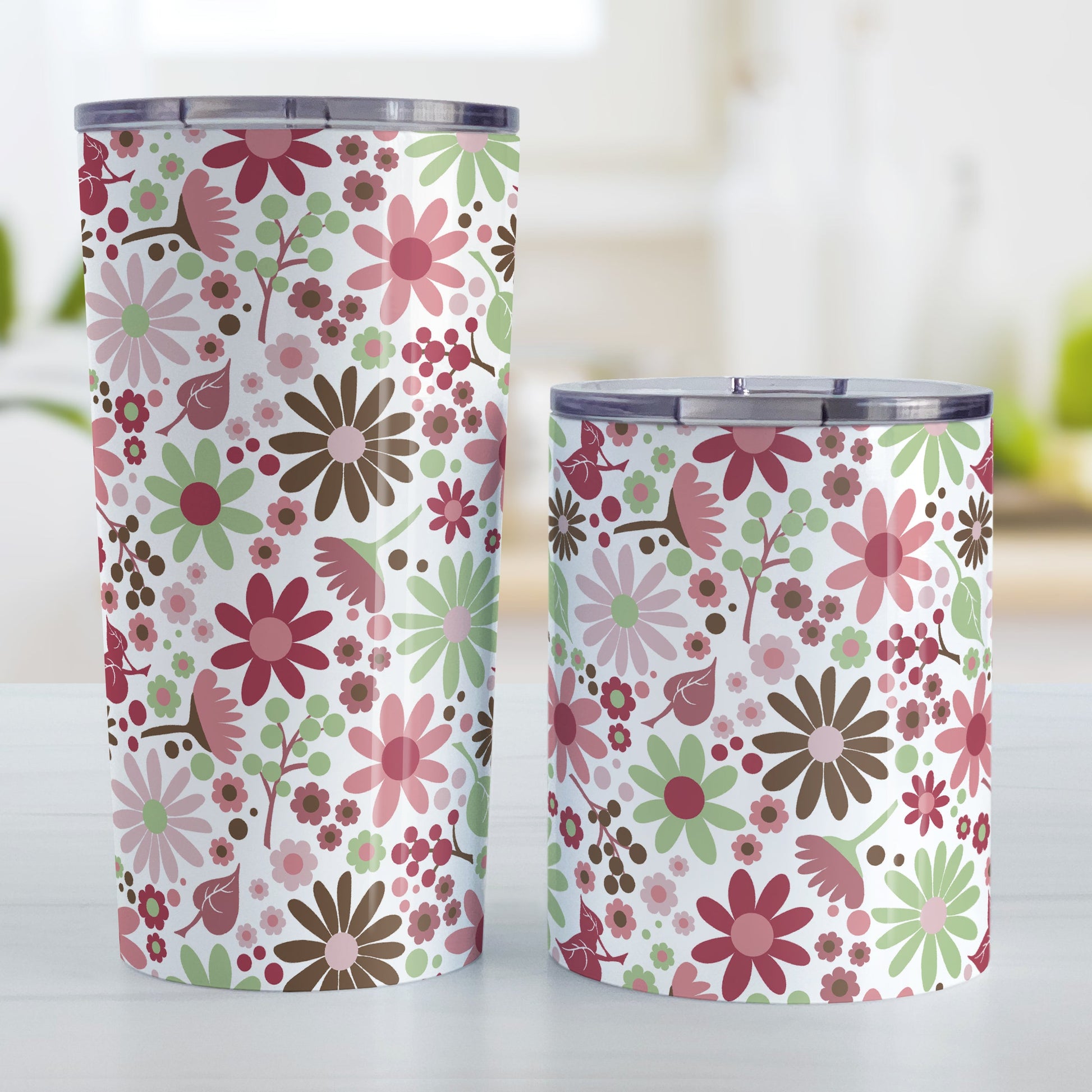 Berry Green Summer Flowers Tumbler Cup (20oz and 10oz, stainless steel insulated) at Amy's Coffee Mugs. Tumbler cups designed with a lovely summer flowers pattern in beautiful berry pink hues, accented with green and brown, that wraps around the cups. Photo shows both sized cups on a table next to each other. 