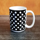Black Polka Dot Mug (15oz, on orange and weathered wood background) at Amy's Coffee Mugs
