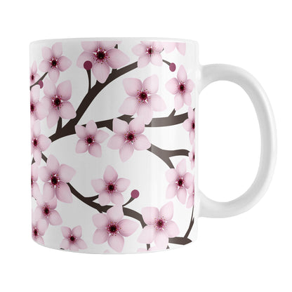 Cherry Blossom Mug (11oz) at Amy's Coffee Mugs. A ceramic coffee mug designed with a pattern of pink cherry blossom flowers on branches that wraps around the mug to the handle.