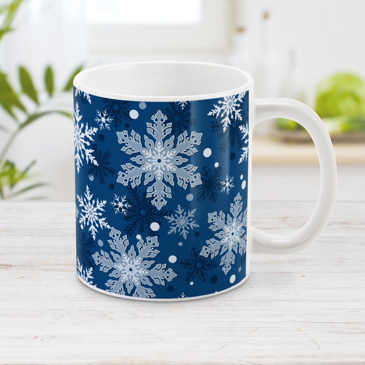 Classic Blue Snowflake Pattern Winter Mug (11oz) at Amy's Coffee Mugs. A ceramic coffee mug designed with a pattern of different shades of blue snowflakes over a classic blue background color that wraps around the mug.