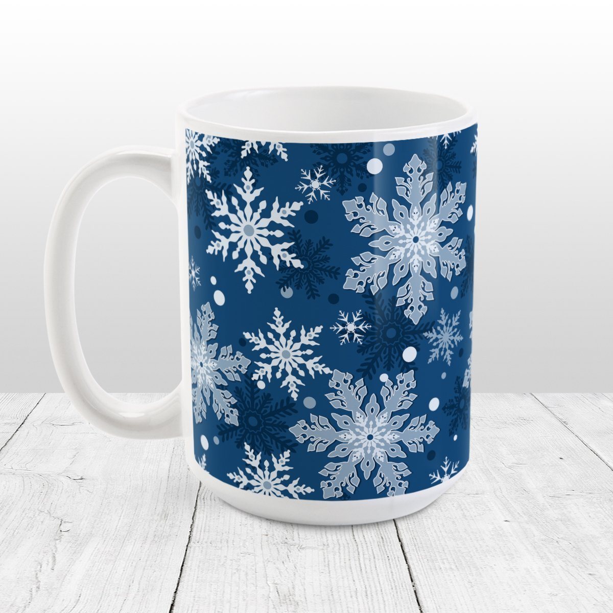 Classic Blue Snowflake Pattern Winter Mug (15oz) at Amy's Coffee Mugs. A ceramic coffee mug designed with a pattern of different shades of blue snowflakes over a classic blue background color that wraps around the mug.