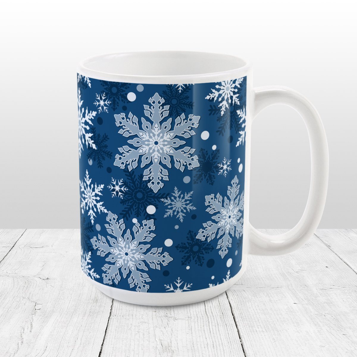 Classic Blue Snowflake Pattern Winter Mug (15oz) at Amy's Coffee Mugs. A ceramic coffee mug designed with a pattern of different shades of blue snowflakes over a classic blue background color that wraps around the mug.