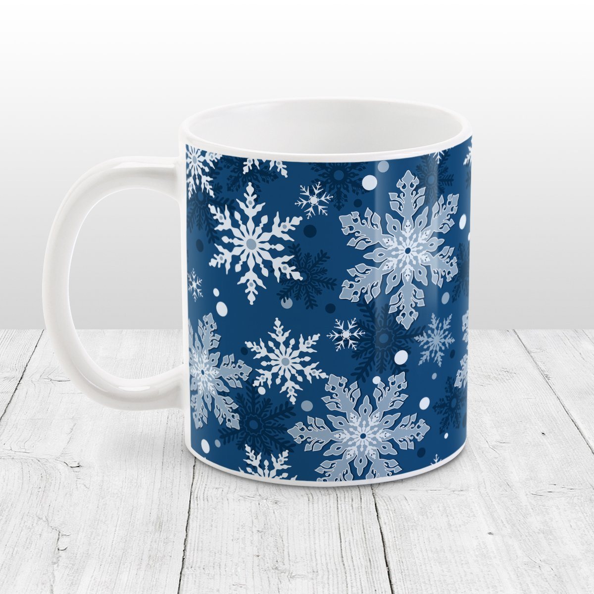 Classic Blue Snowflake Pattern Winter Mug (11oz) at Amy's Coffee Mugs. A ceramic coffee mug designed with a pattern of different shades of blue snowflakes over a classic blue background color that wraps around the mug.